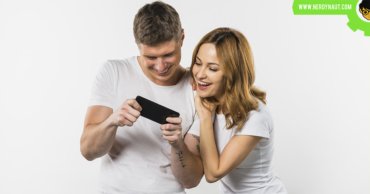 Playing mobile games by a couple