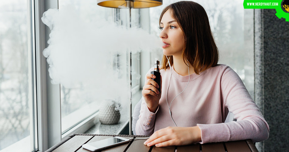 Woman vaping near a window