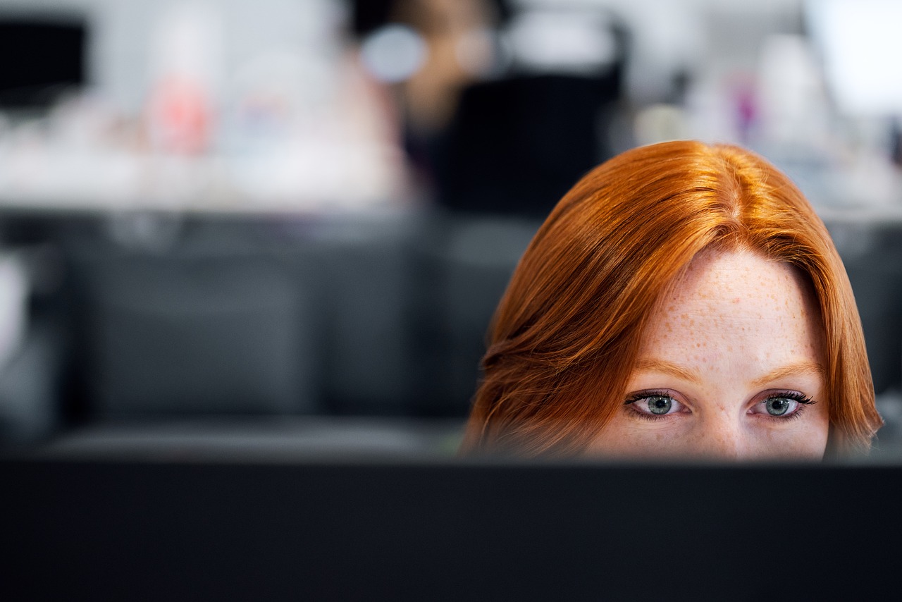WOman watching a computer screen